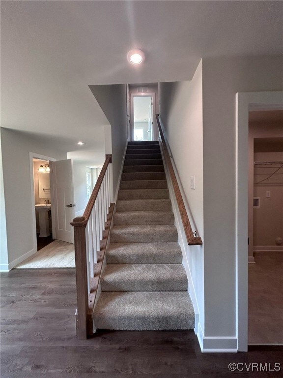 Stairs featuring baseboards, wood finished floors,