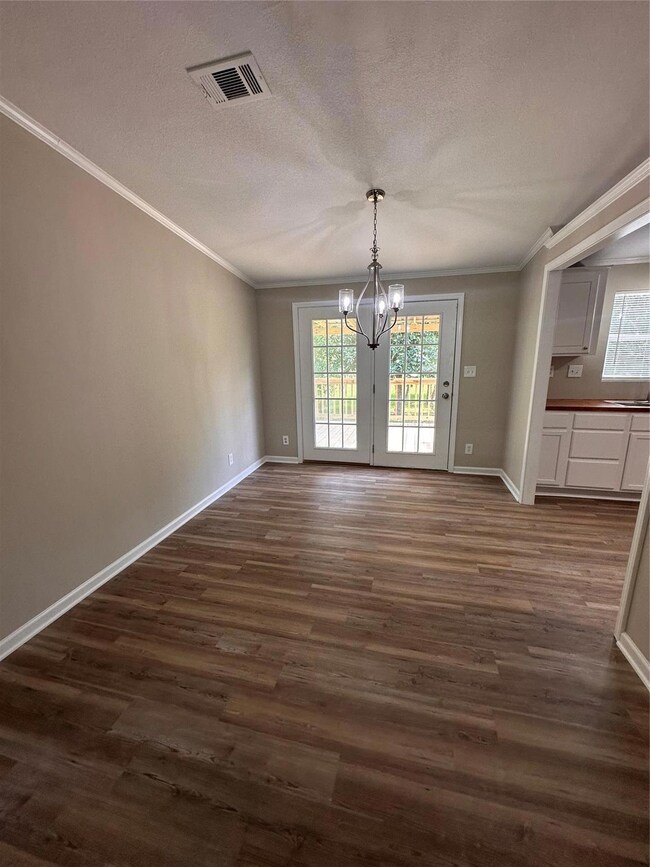 Unfurnished dining area with a chandelier, visible