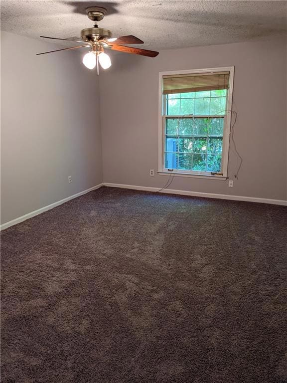 Carpeted spare room featuring ceiling fan and a textured ceiling
