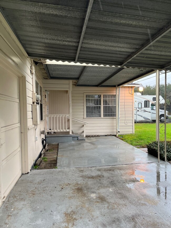 This photo shows a covered carport area with a con