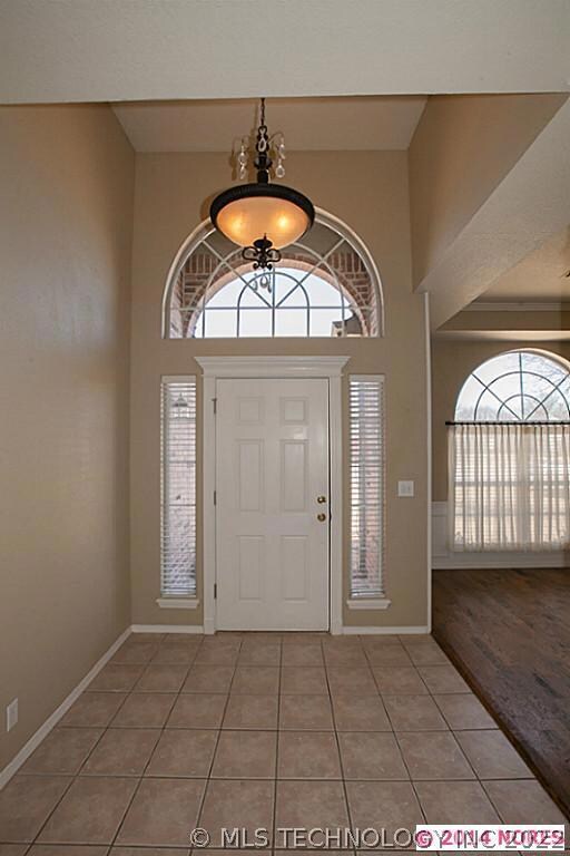Dramatic entry with storm door, tile flooring and