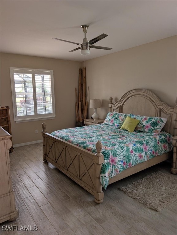 Bedroom with light wood-style floors, ceiling fan,