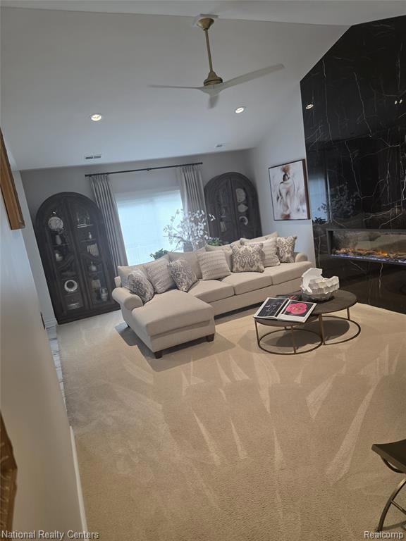Living room with carpet floors, recessed lighting, and ceiling fan
