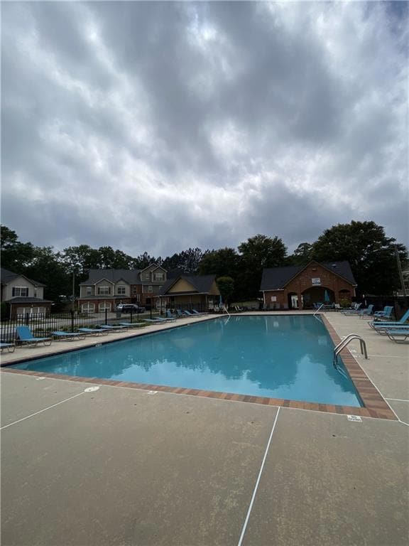 Community pool with a patio
