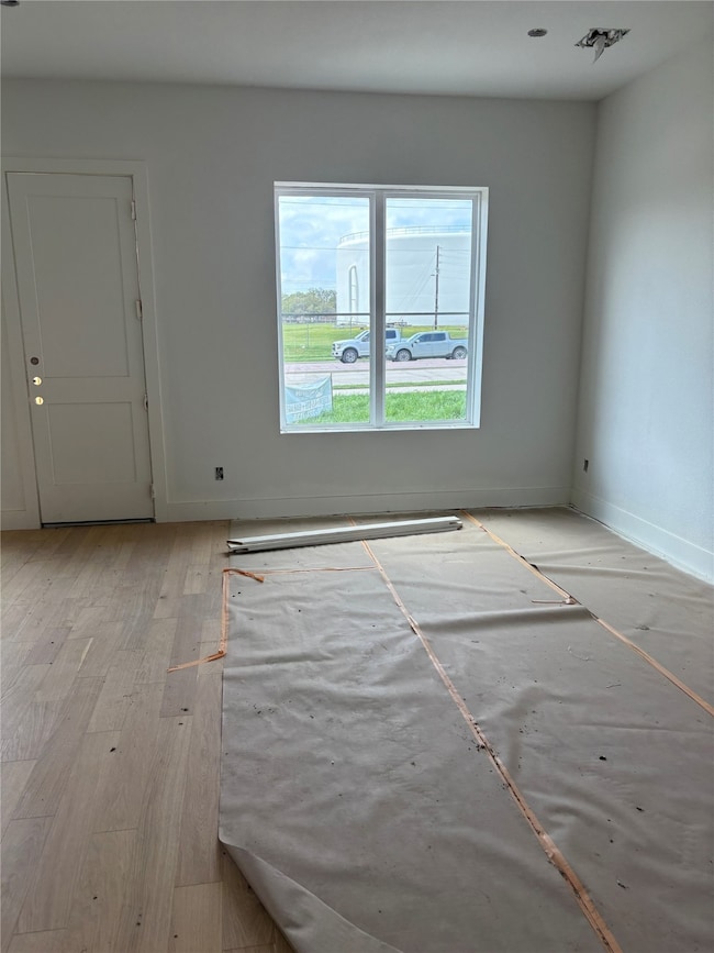 Living space features wood floors open to kitchen