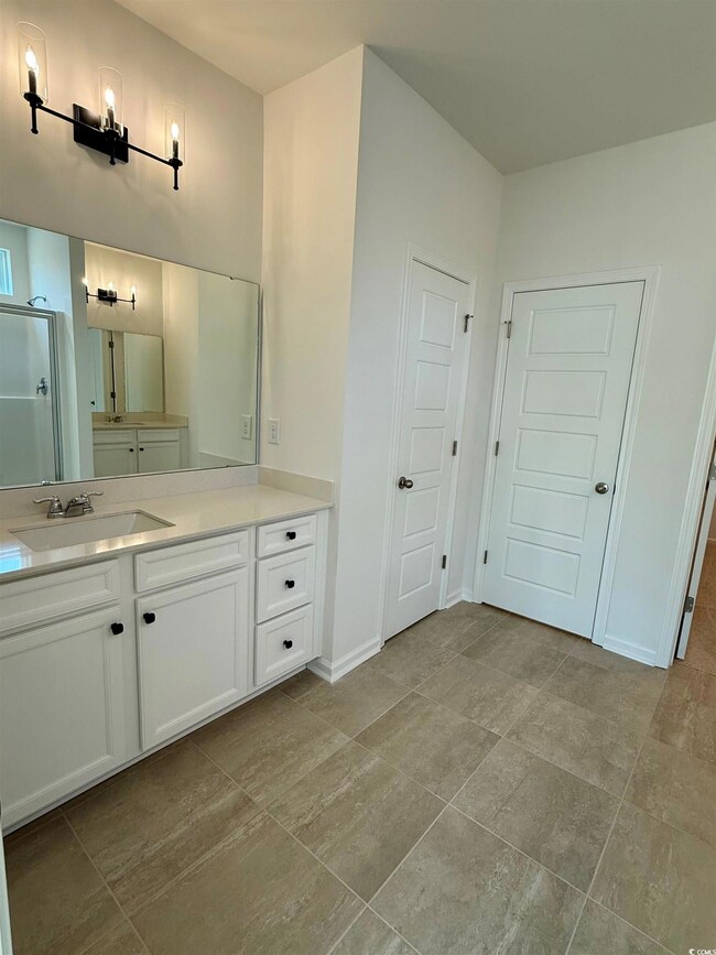 Full bathroom featuring a shower with shower door,