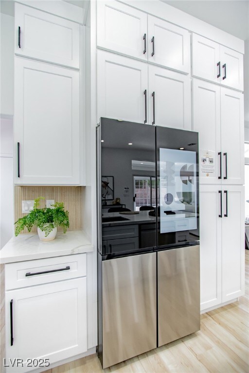 Kitchen featuring smart refrigerator, white cabine