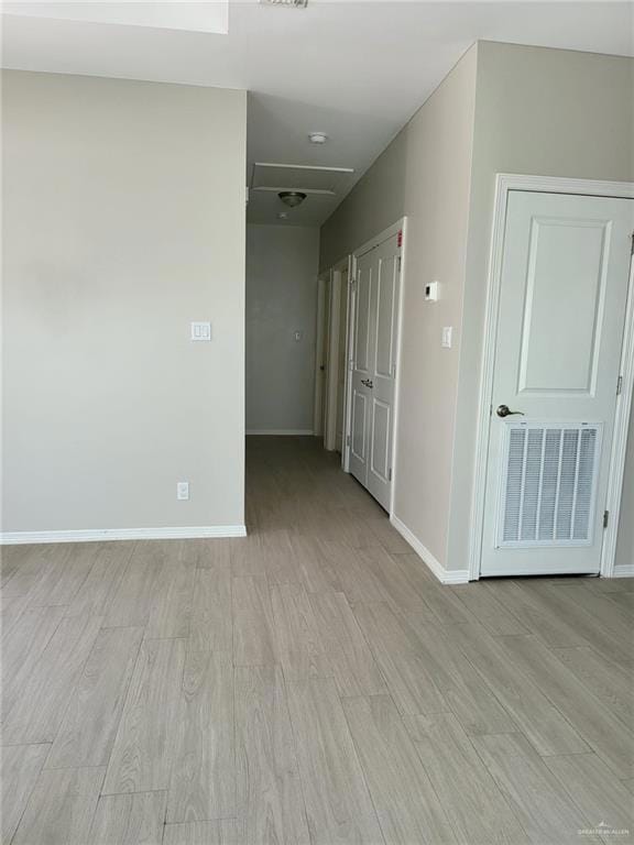 Unfurnished room with light wood-type flooring and baseboards