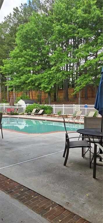 View of pool featuring a fenced in pool, a patio a