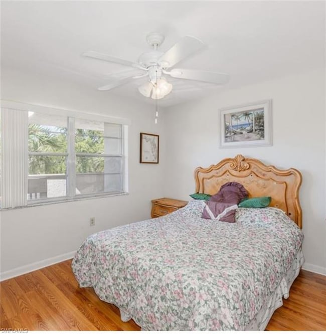 Bedroom featuring wood finished floors and ceiling fan