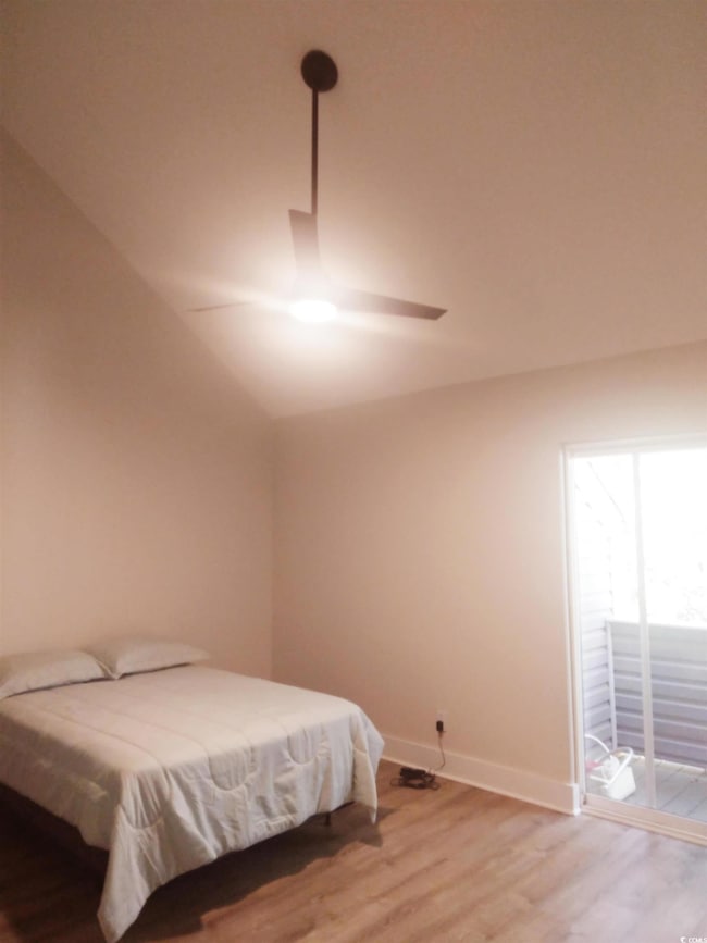Bedroom featuring access to exterior, vaulted ceil