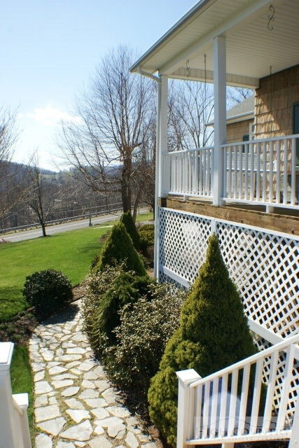 Beautiful, mature landscaping surrounds the entry