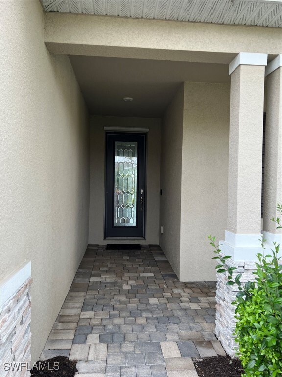 Property entrance with stucco siding