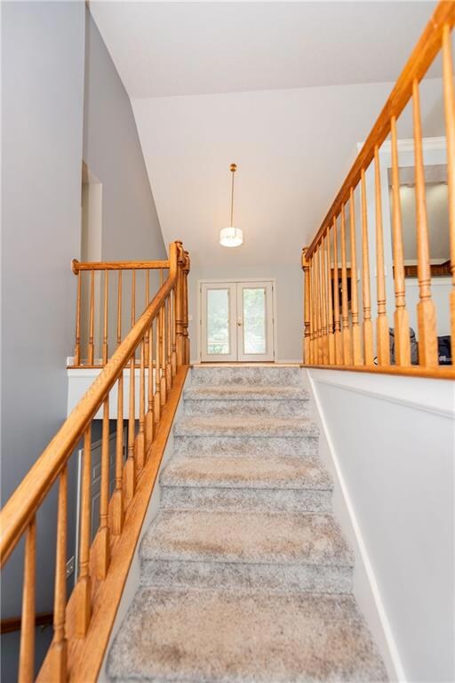 Staircase with lofted ceiling