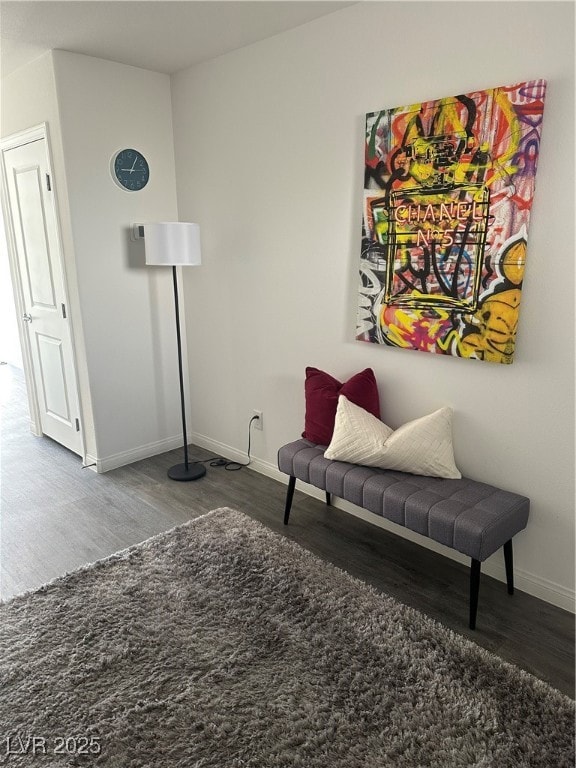Sitting room with wood finished floors and baseboa