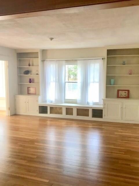 Living room with built-in shelving. ...