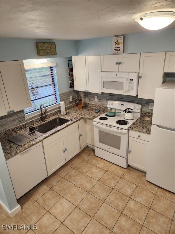 Kitchen featuring stove, refrigerator, dishwashing