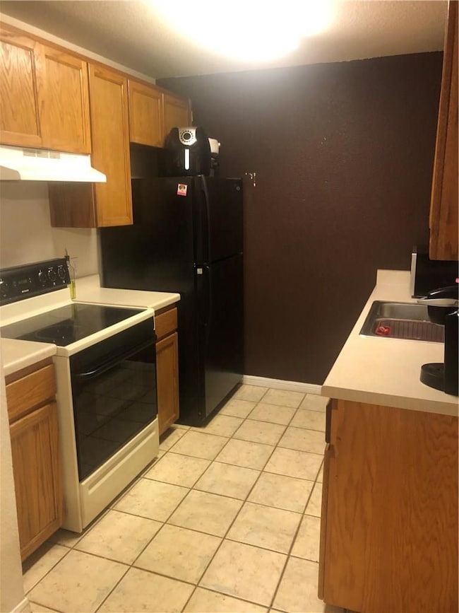 Kitchen with range with electric cooktop, under c