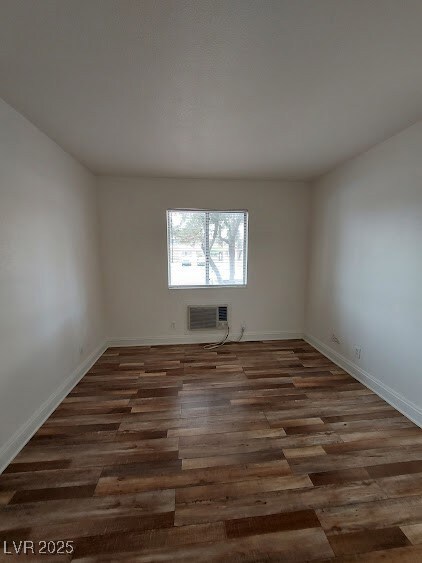 Spare room with wood finished floors and baseboard
