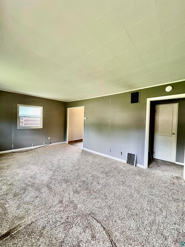 Empty room featuring carpet floors