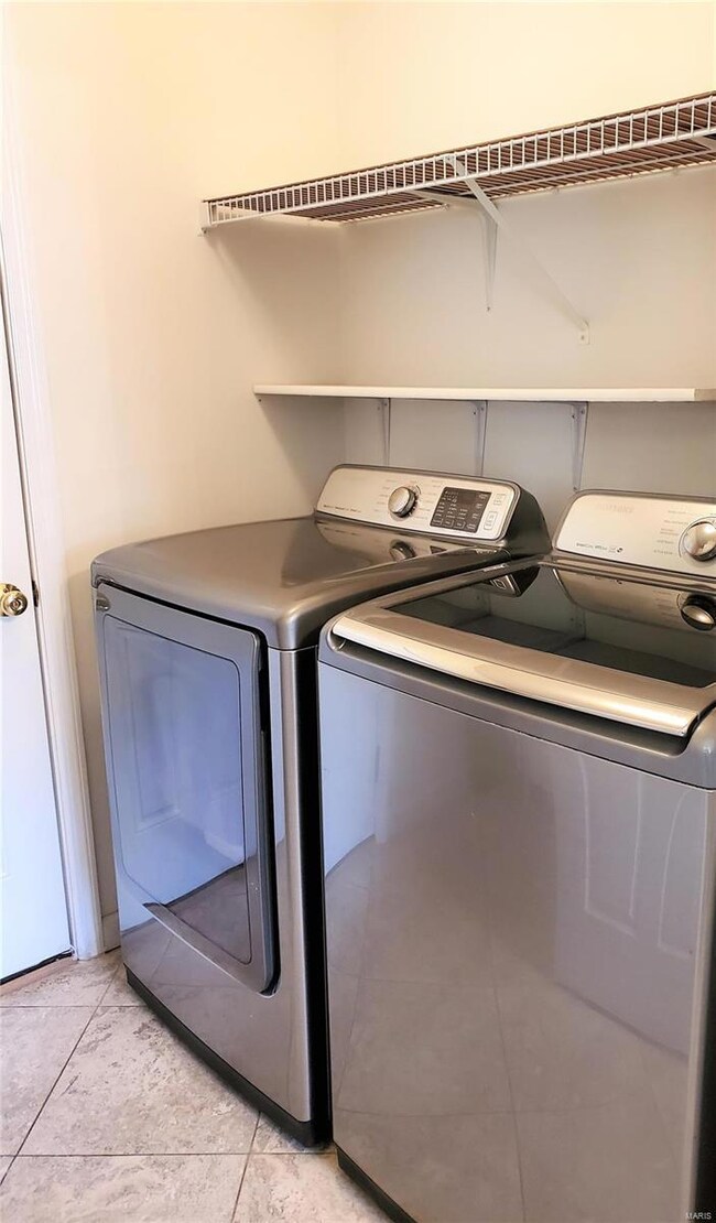 Newer Samsung Washer and Dryer plus cabinet storag