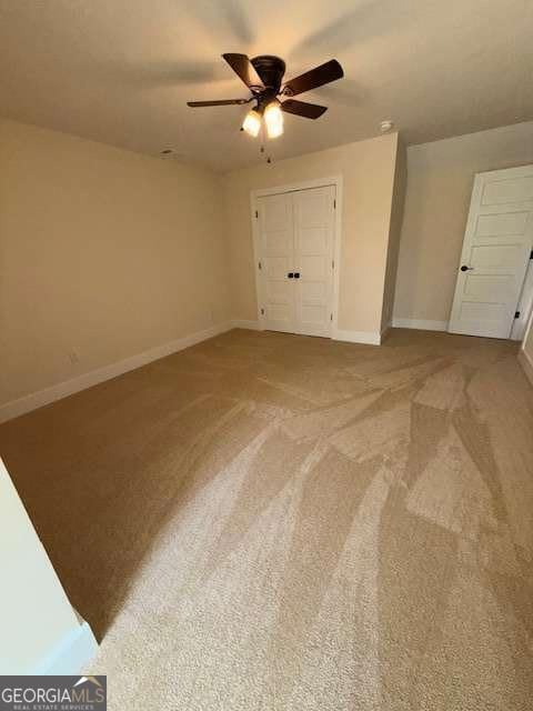 Upstairs bedroom with carpet and large walk in closet.