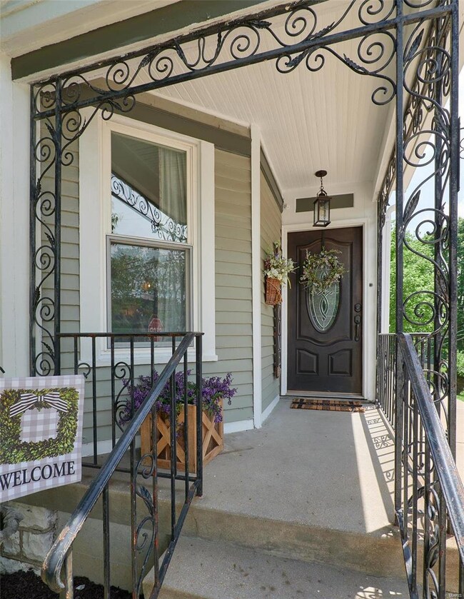 A beautiful front door and inviting porch welcome 