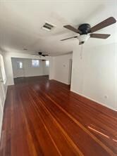 Unfurnished living room with a ceiling fan and da