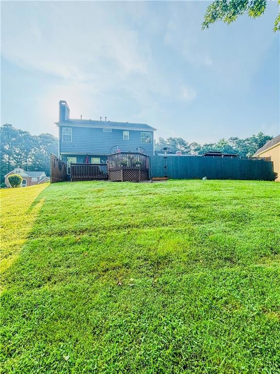 View of yard with a wooden deck