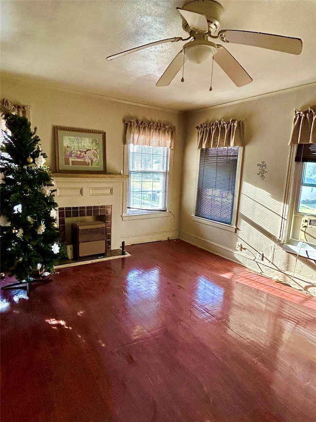 Unfurnished living room with baseboards, wood fini