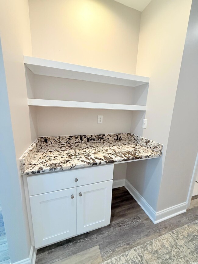 Interior space featuring baseboards and wood finished floors