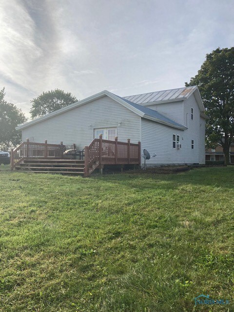 Back of house with deck