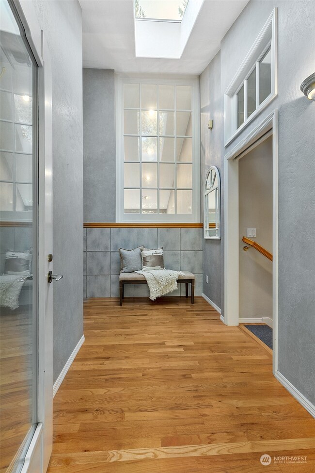 Entryway featuring hardwoods and so much stunning glass!