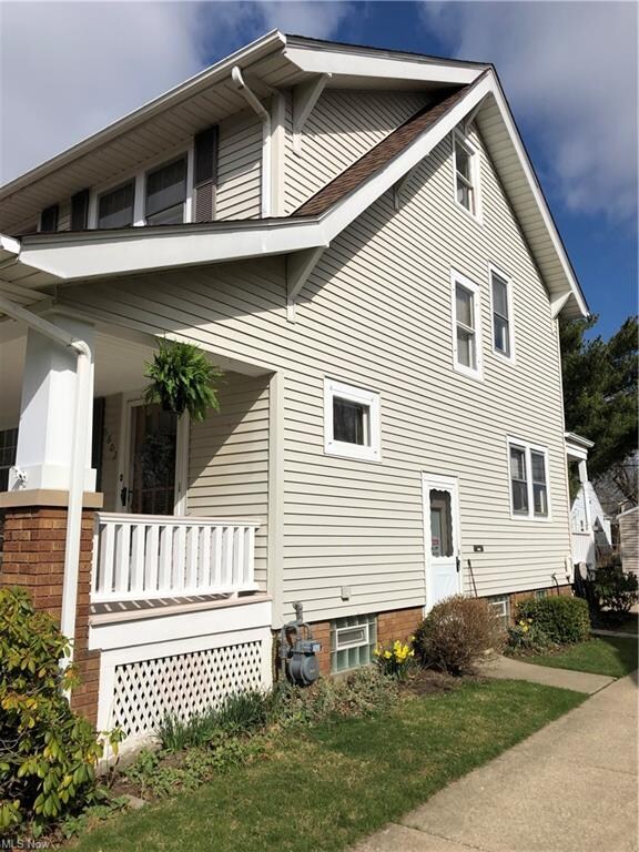 Flowers are blooming!  Glass block basement windows with vents!  Vinyl sided.