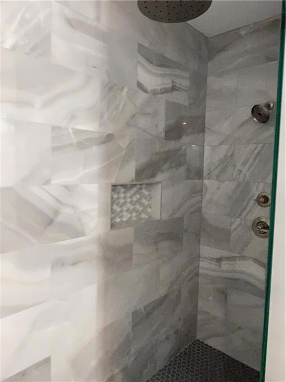 Large walk-in shower, tiled from floor to ceiling,
