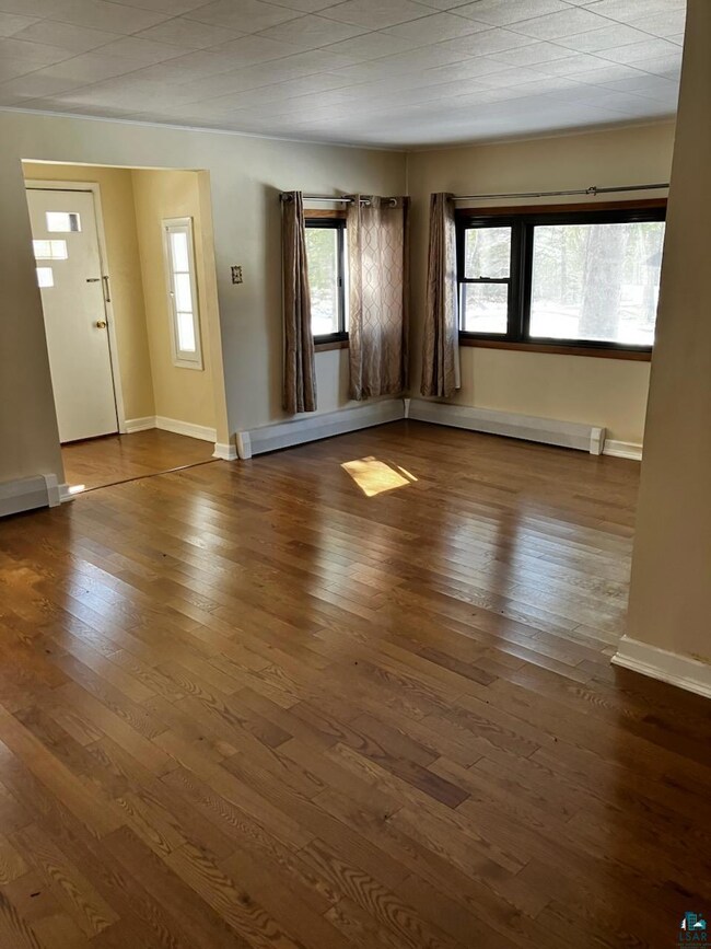 Unfurnished room featuring a baseboard heating uni