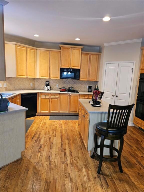 Kitchen featuring a breakfast bar area, tasteful b