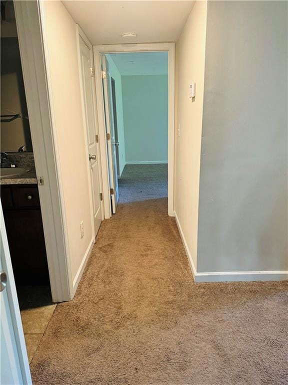 Hall featuring light colored carpet and sink