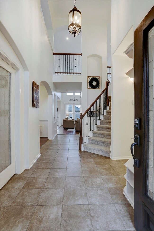 Inviting foyer greets your guests and leads to the living areas.  You will transition through a lovely corridor revealing fresh paint, elegant archways with delightful details and high ceilings with accents of double crown molding.  The entire living space is full of natural light!