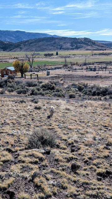 View of mountain background featuring rural landscape
