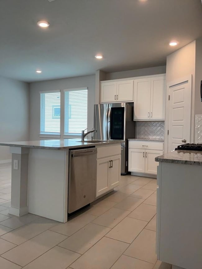 Kitchen featuring stainless steel appliances, whi