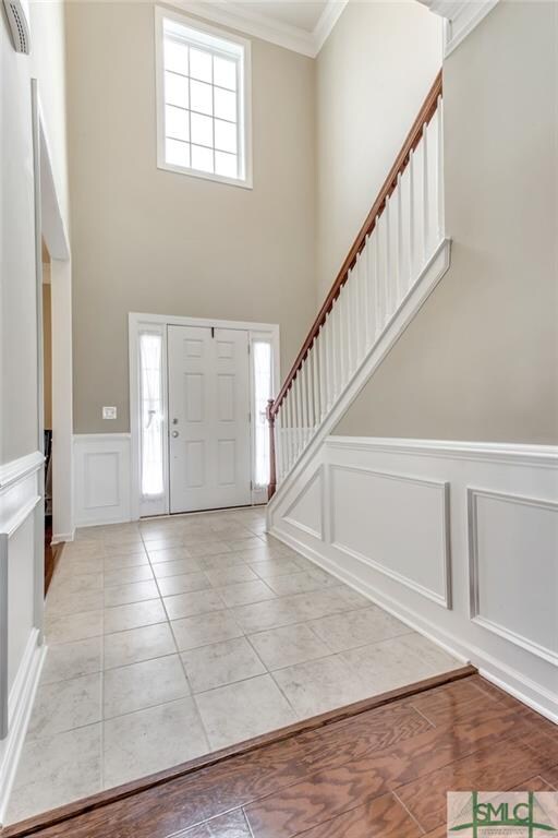 Two-story foyer with bright light, custom crown mo