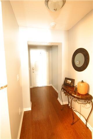 Foyer with hardwoods and chandelier