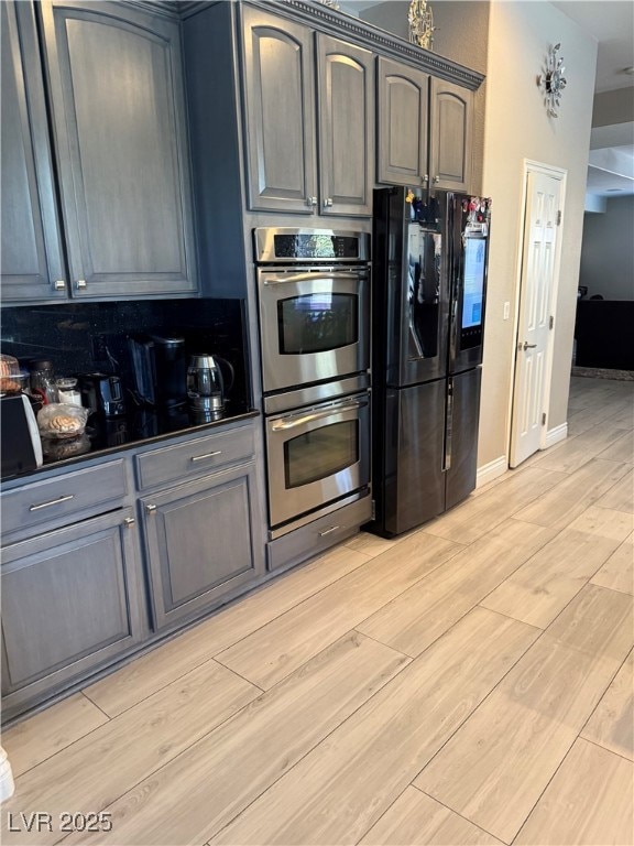 Kitchen featuring smart refrigerator, double oven,