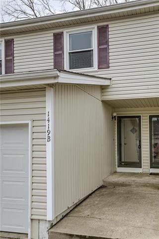 Front entry has a storm door landing area with entrance door to garage.