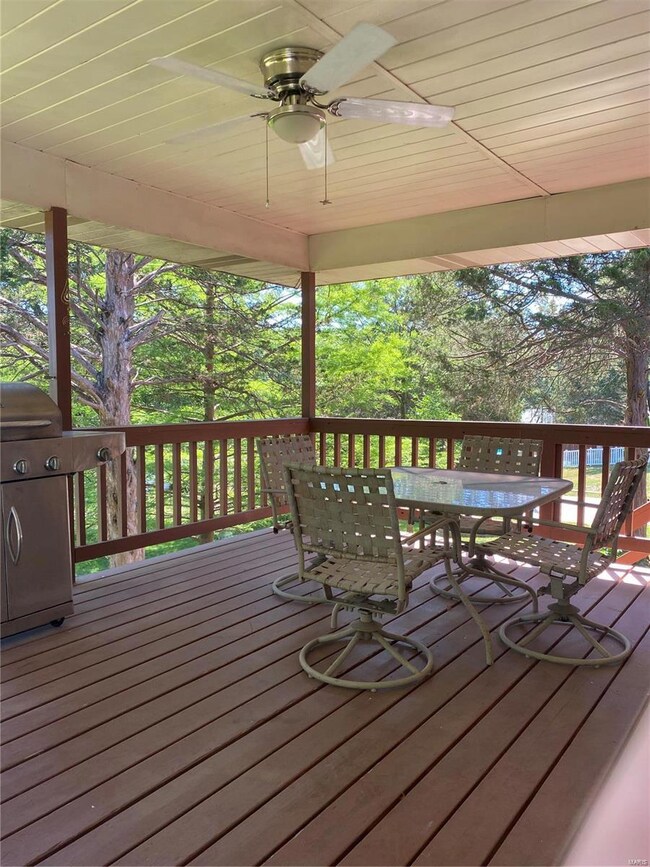 Covered deck w/steps to backyard