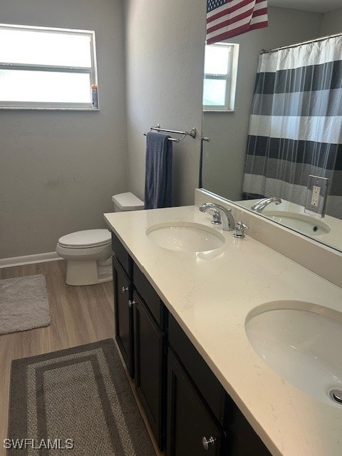 Full bath with toilet, wood finished floors, doubl