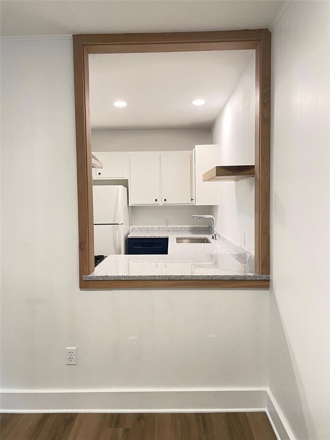 Kitchen with freestanding refrigerator, a sink, d