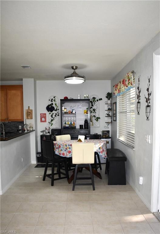Dining area featuring light tile patterned floors 