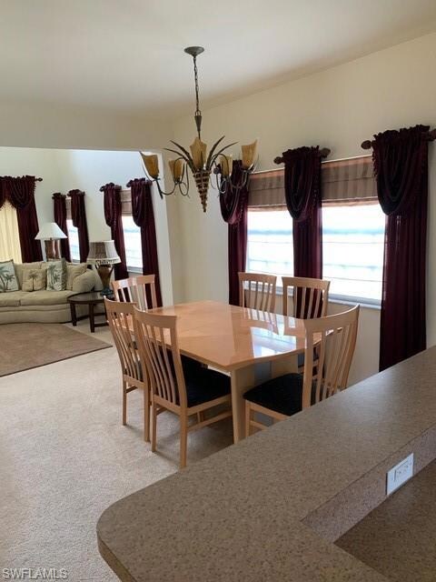 Formal dining area off kitchen leads to vaulted ce
